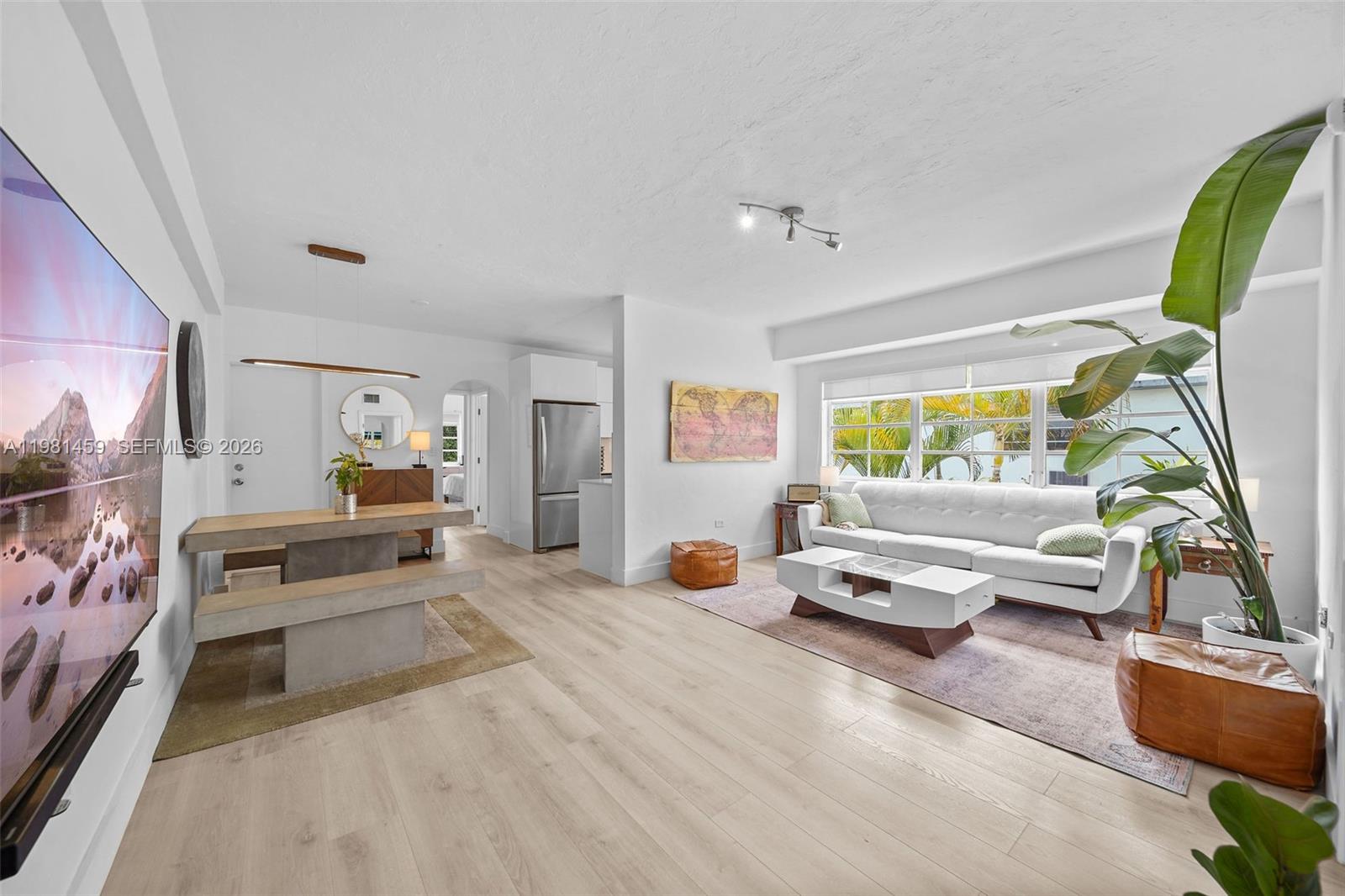 832 15th Street, Unit 4 Miami Beach, FL 33139 - Photo 4 of 17 a bedroom with furniture and a large window