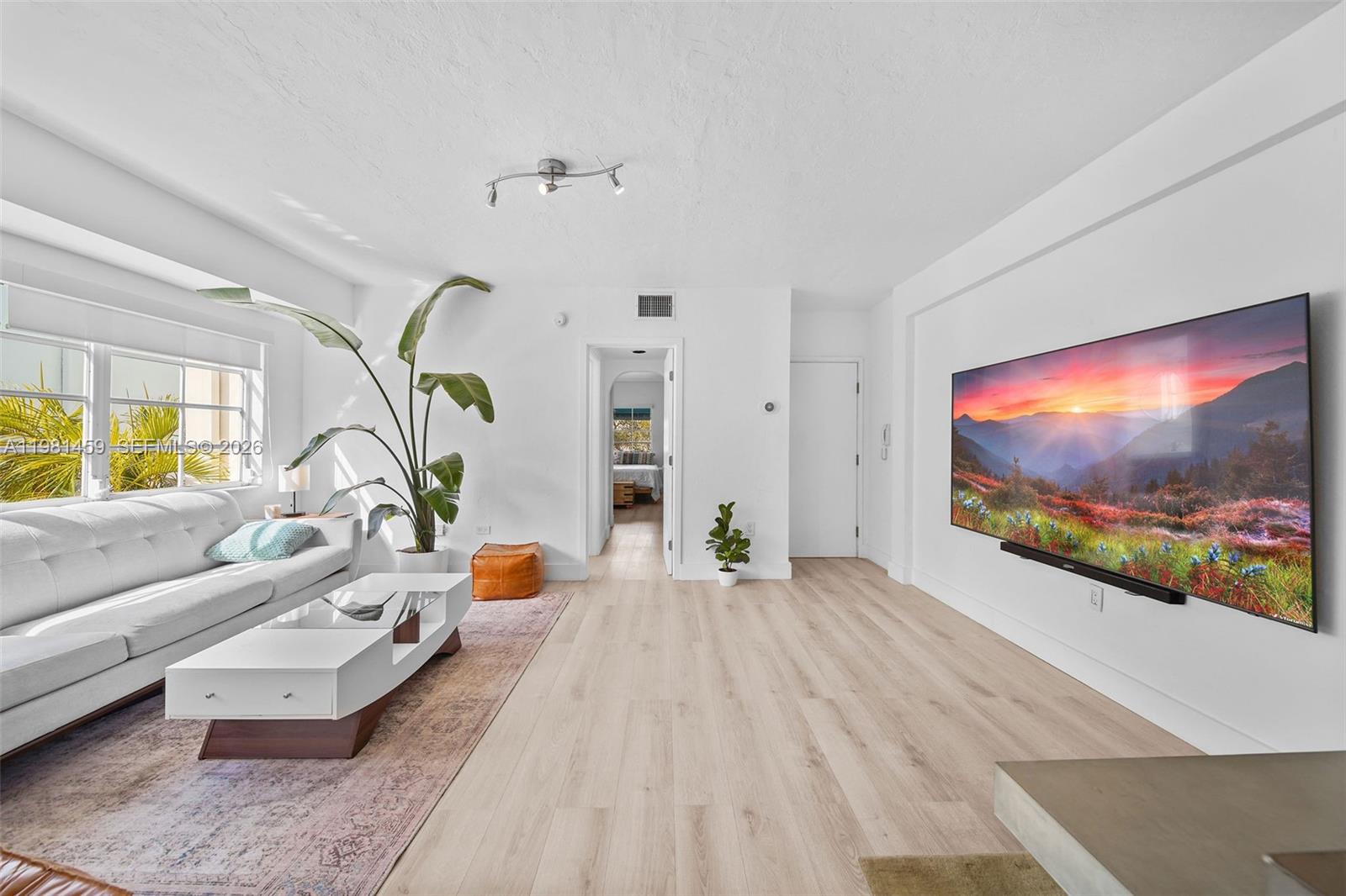 832 15th Street, Unit 4 Miami Beach, FL 33139 - Photo 5 of 17 a living room with furniture and a flat screen tv