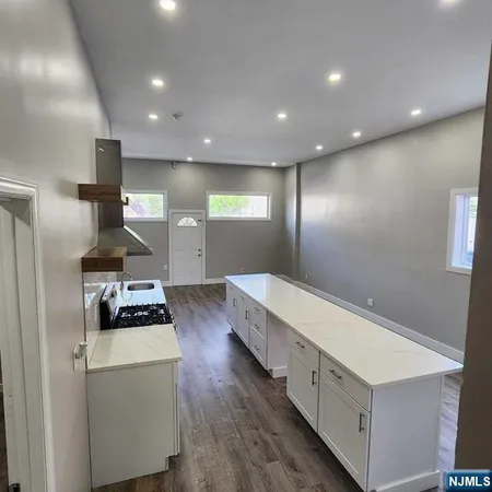 a kitchen with stove and refrigerator