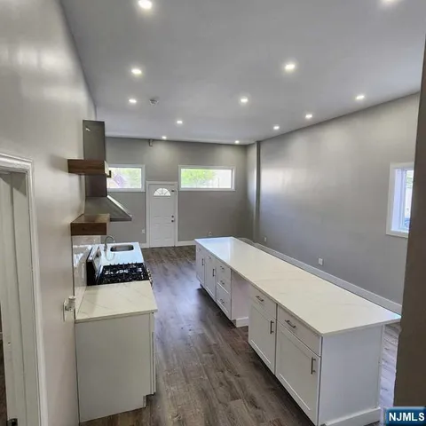 a kitchen with stove and refrigerator