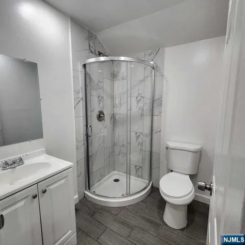a bathroom with a toilet a sink and shower