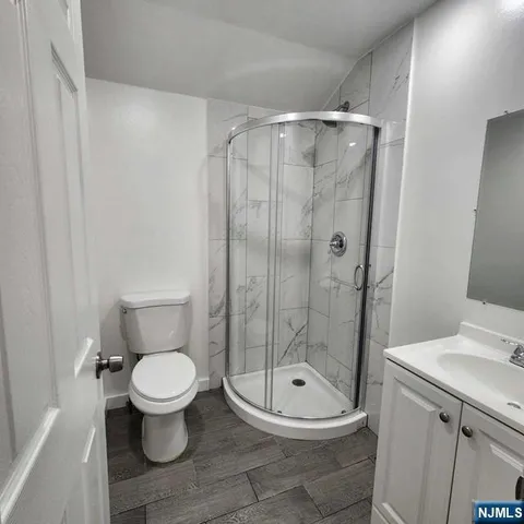 a bathroom with a toilet and a shower