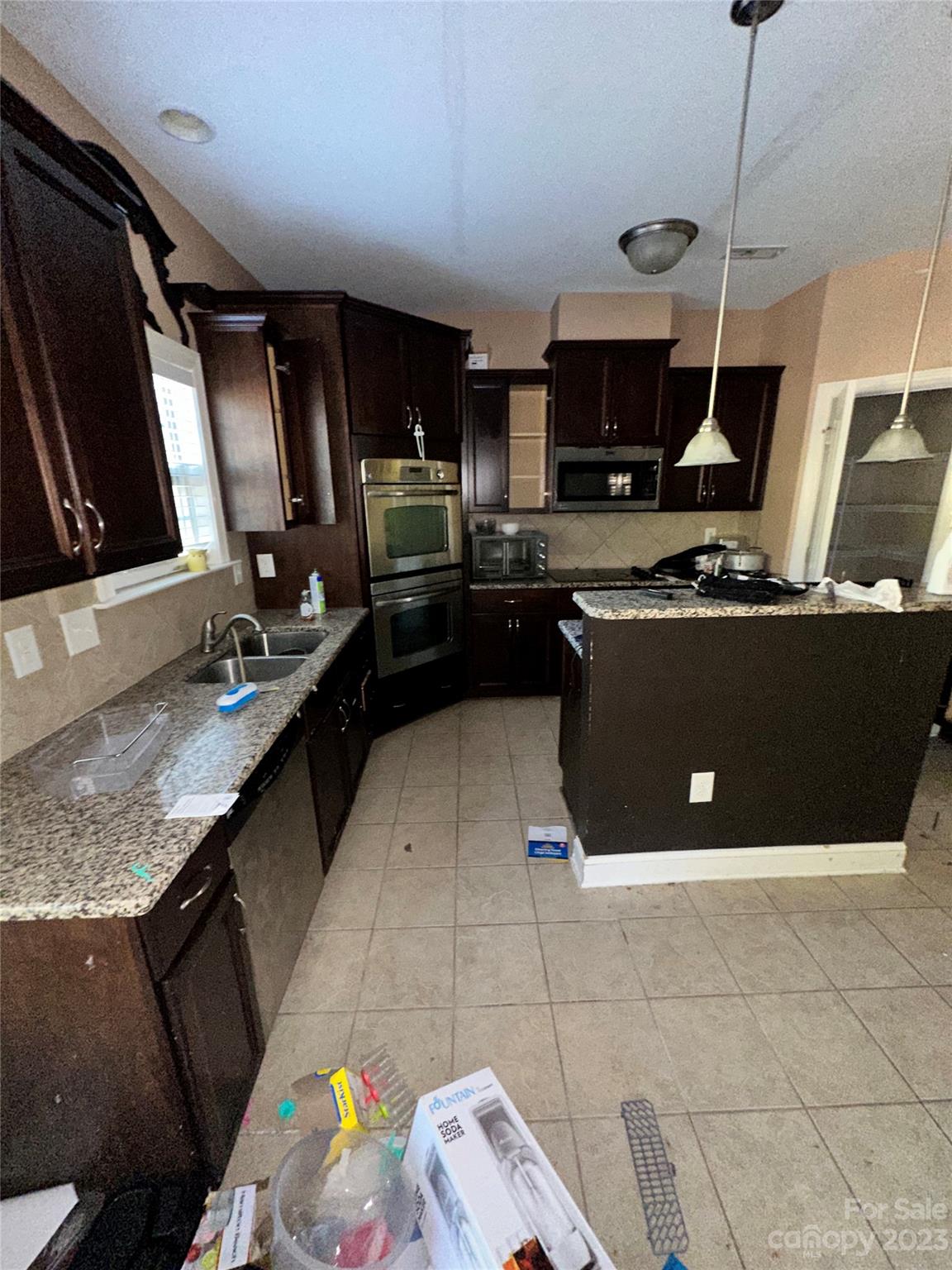 131 Revolutionary Road Cameron, NC 28326 - Photo 3 of 16 a kitchen with kitchen island granite countertop a stove and a sink