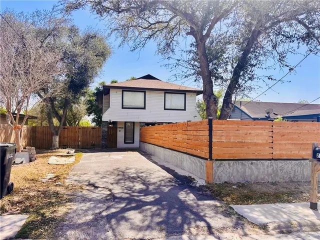 a view of a house with a yard covered in snow