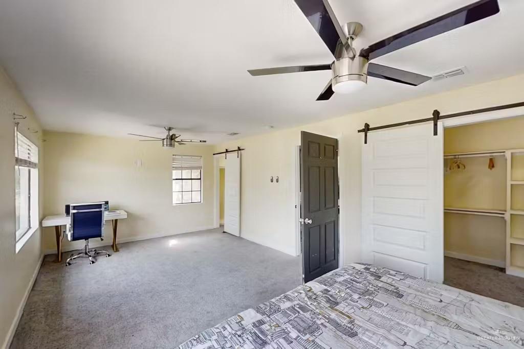 2153 El Rancho Road McAllen, TX 78503 - Photo 15 of 36 a bedroom with a bed and a refrigerator