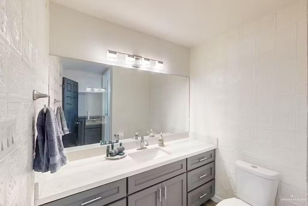 2153 El Rancho Road McAllen, TX 78503 - Photo 16 of 36 a bathroom with a sink a toilet and vanity