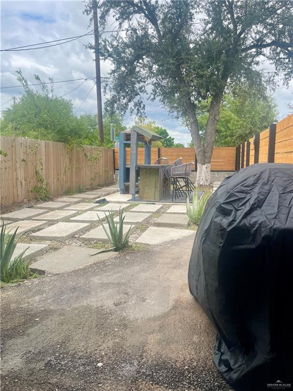 2153 El Rancho Road McAllen, TX 78503 - Photo 30 of 36 a backyard of a house with large trees and outdoor seating