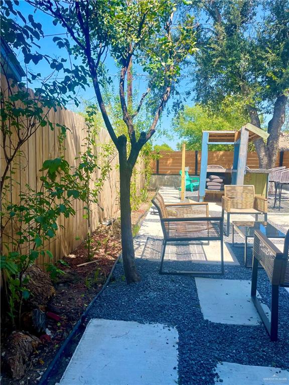 2153 El Rancho Road McAllen, TX 78503 - Photo 34 of 36 a wooden bench sitting in front of a house