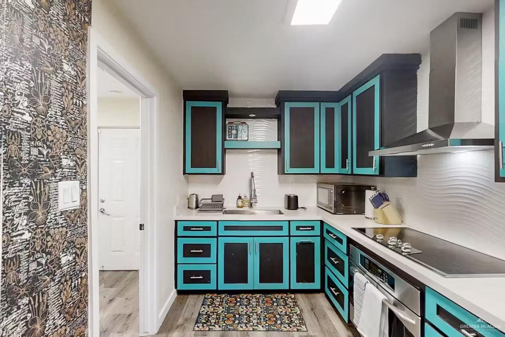 2153 El Rancho Road McAllen, TX 78503 - Photo 6 of 36 a kitchen that has a sink and a stove in it