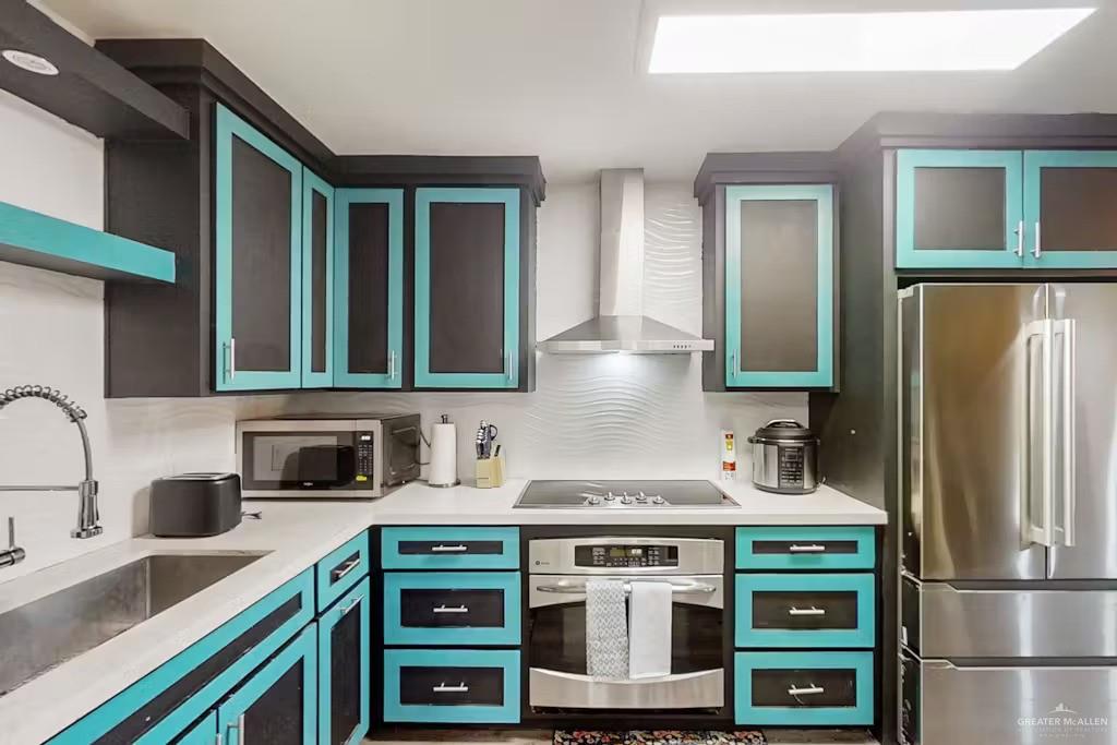 2153 El Rancho Road McAllen, TX 78503 - Photo 7 of 36 a kitchen with stainless steel appliances granite countertop a stove a refrigerator and a sink