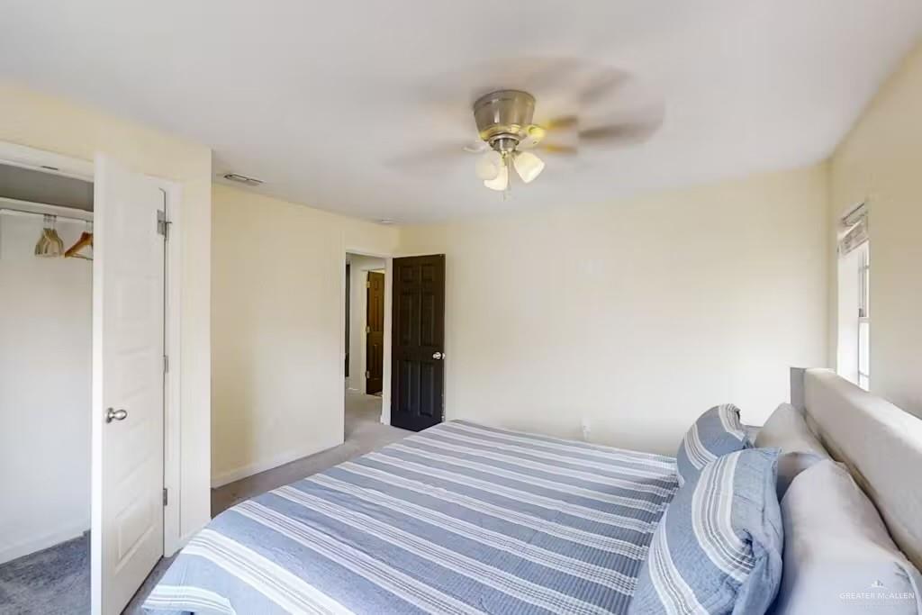 2153 El Rancho Road McAllen, TX 78503 - Photo 10 of 36 a bedroom with a bed and a chandelier