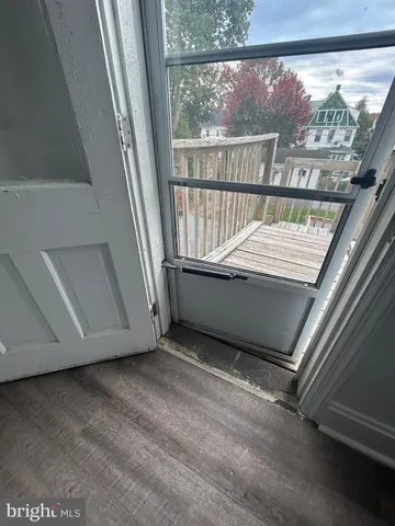 a view of a room with wooden floor and windows