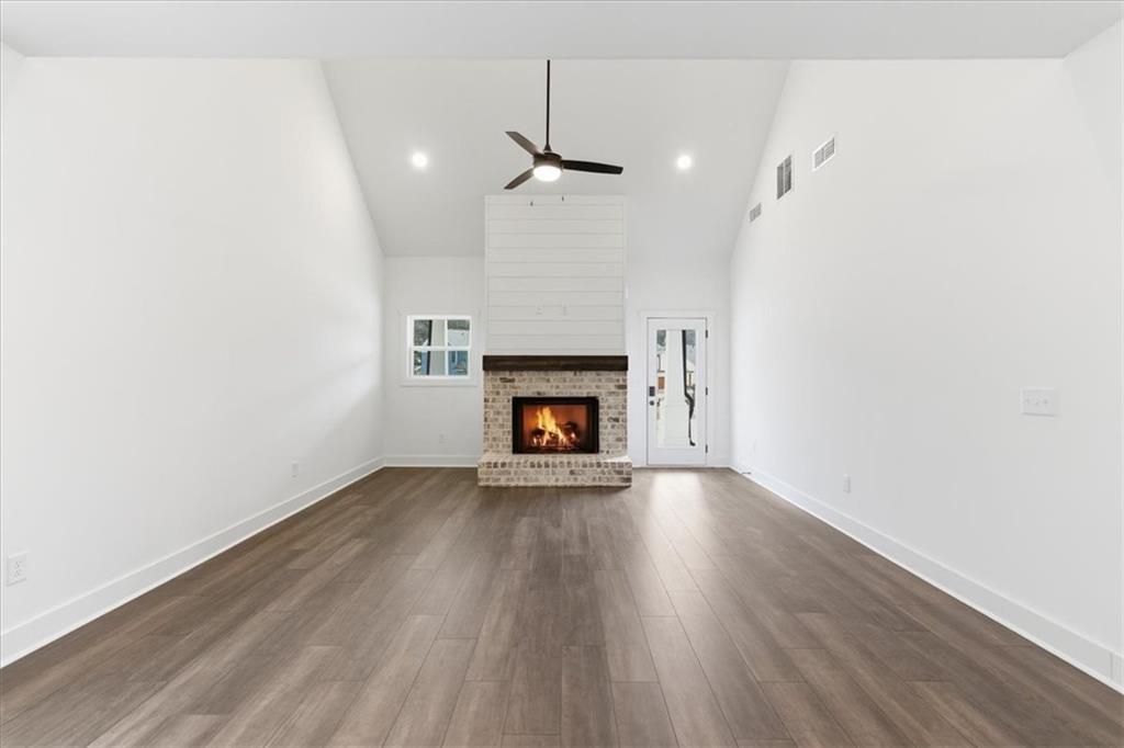 135 Old Alabama Road Southeast Emerson, GA 30137 - Photo 29 of 57 a view of an empty room with wooden floor fireplace and a window