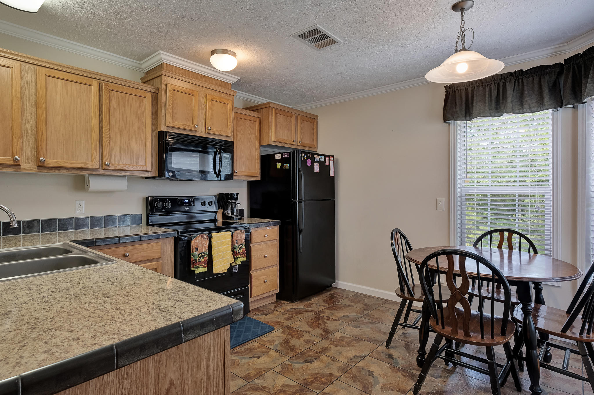 2157 Dr Nelson Road DeFuniak Springs, FL 32433 - Photo 6 of 23 a kitchen with stainless steel appliances granite countertop a stove a refrigerator a sink a dining table and chairs
