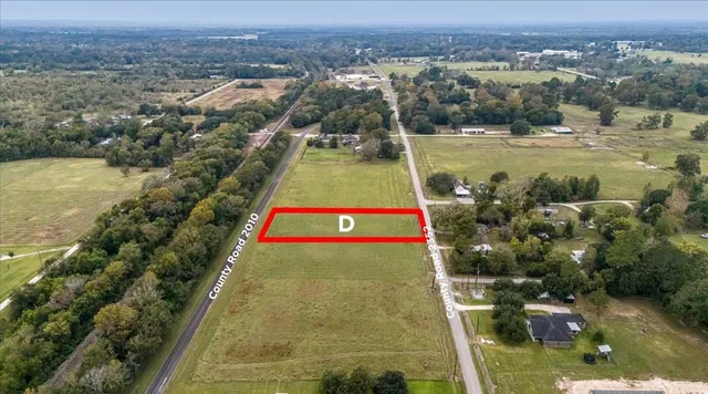 an aerial view of residential houses with outdoor space and lake view