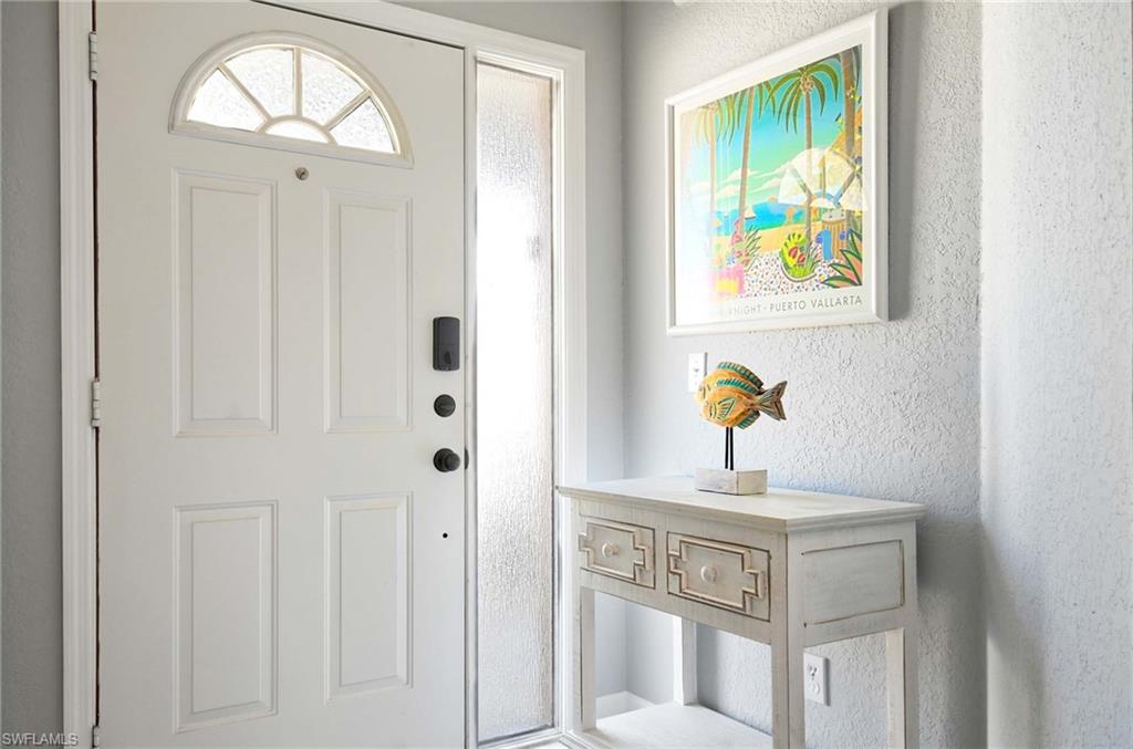 9022 Michael Circle, Unit 2210 Naples, FL 34113 - Photo 12 of 36 a view of an entryway with wooden floor