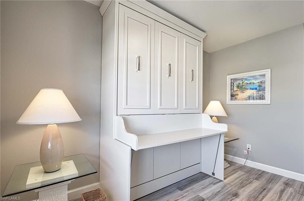 9022 Michael Circle, Unit 2210 Naples, FL 34113 - Photo 15 of 36 a bathroom with a sink and a mirror