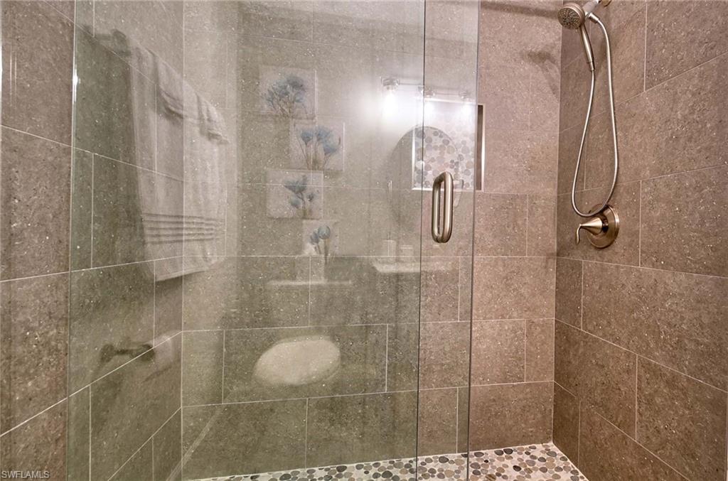 9022 Michael Circle, Unit 2210 Naples, FL 34113 - Photo 17 of 36 a bathroom with a shower