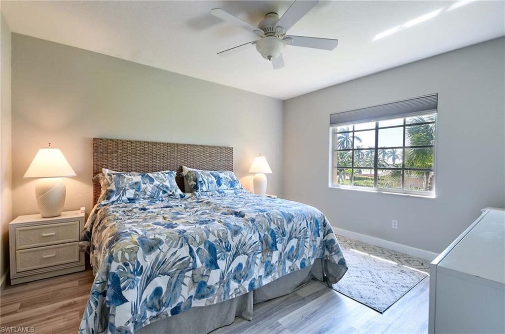 9022 Michael Circle, Unit 2210 Naples, FL 34113 - Photo 18 of 36 a bedroom with a bed and window