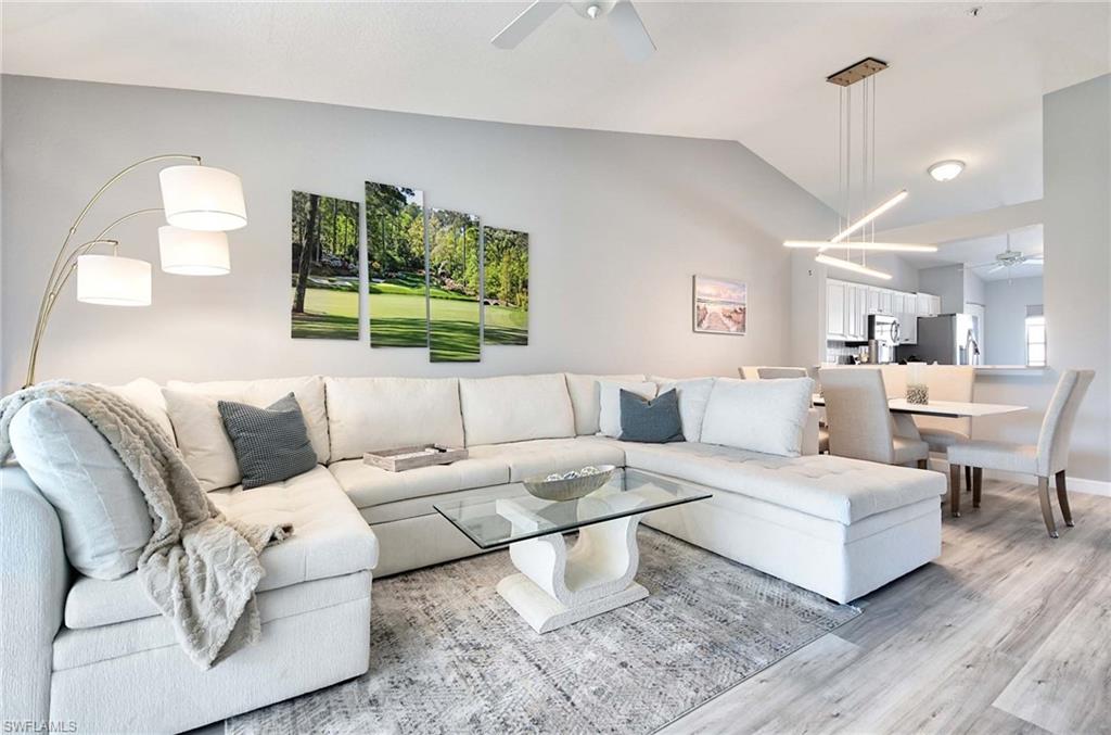 9022 Michael Circle, Unit 2210 Naples, FL 34113 - Photo 2 of 36 a living room with furniture and a large window