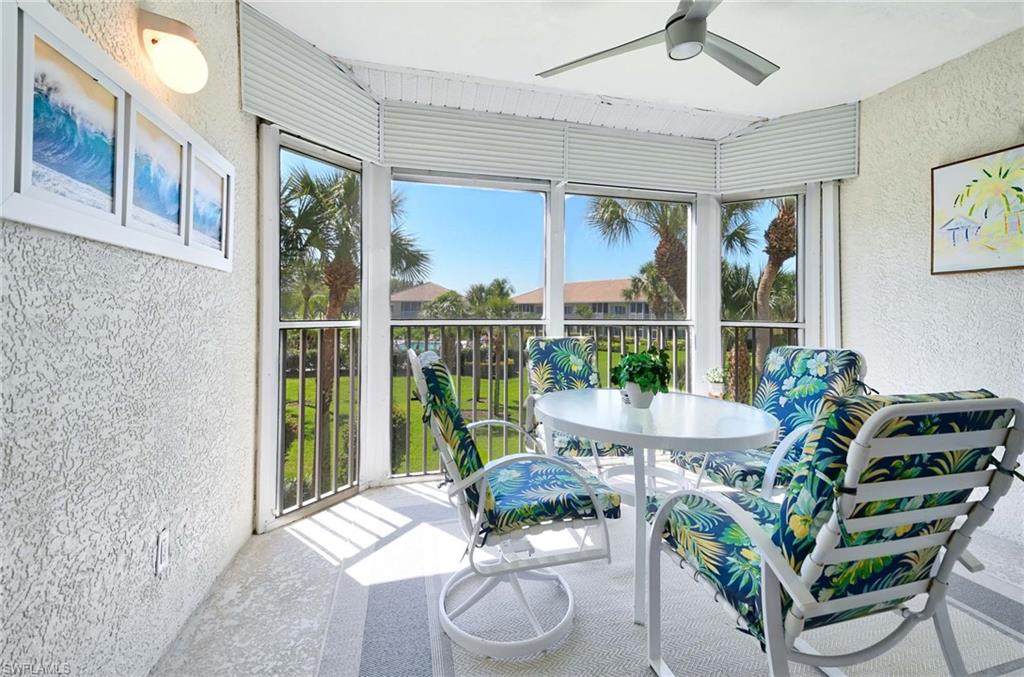 9022 Michael Circle, Unit 2210 Naples, FL 34113 - Photo 23 of 36 a living room with furniture and a potted plant