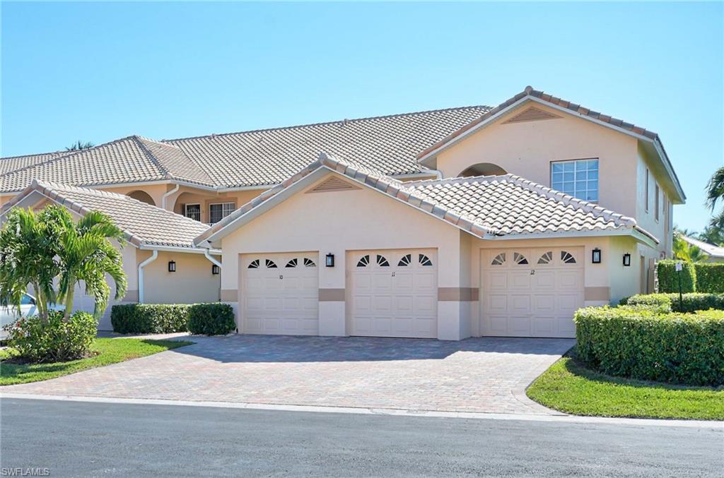 9022 Michael Circle, Unit 2210 Naples, FL 34113 - Photo 26 of 36 front view of house with a yard
