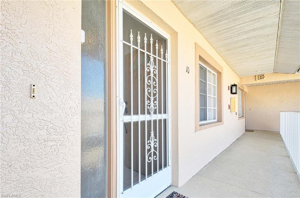 9022 Michael Circle, Unit 2210 Naples, FL 34113 - Photo 27 of 36 a view of front door of a house