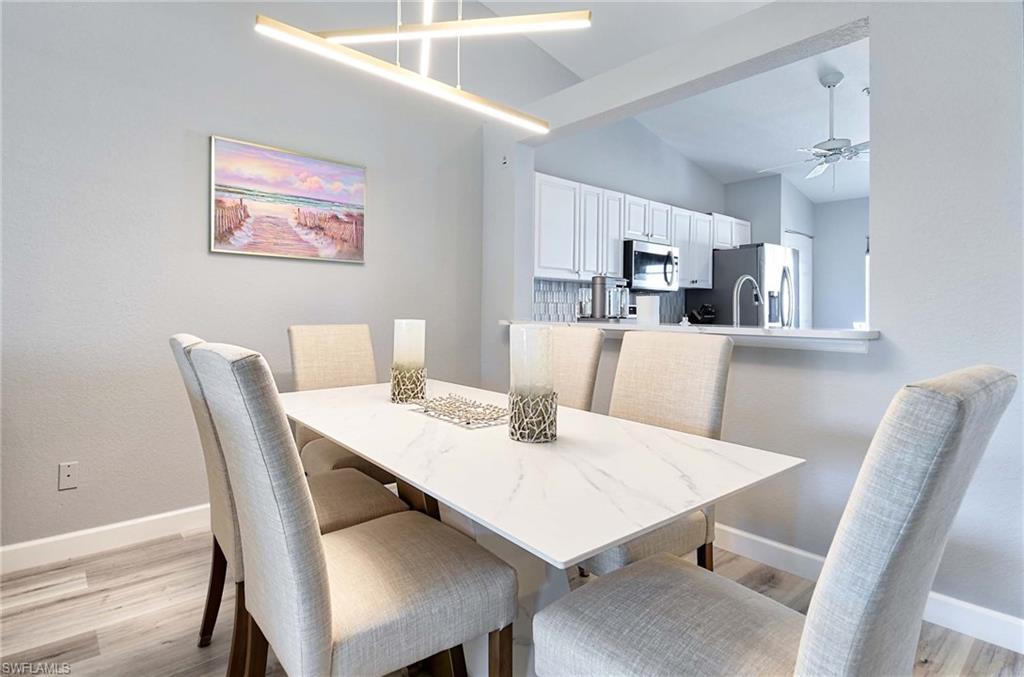 9022 Michael Circle, Unit 2210 Naples, FL 34113 - Photo 3 of 36 a view of a dining room with furniture
