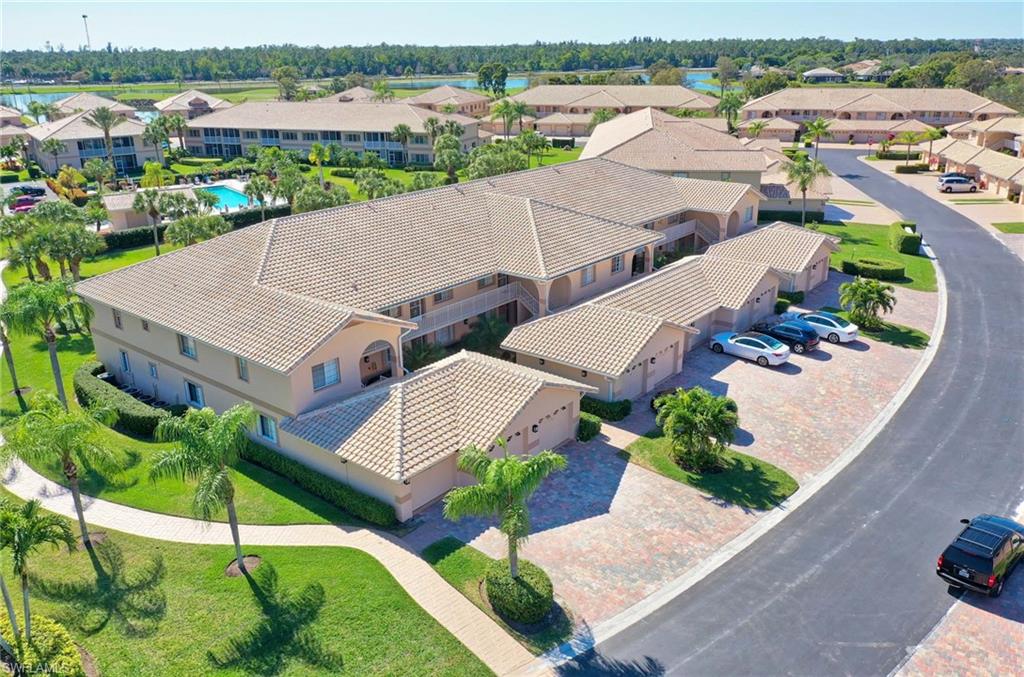 9022 Michael Circle, Unit 2210 Naples, FL 34113 - Photo 32 of 36 an aerial view of a house with a garden and lake view