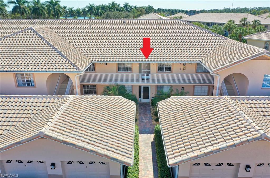 9022 Michael Circle, Unit 2210 Naples, FL 34113 - Photo 36 of 36 a front view of a building with glass space and windows