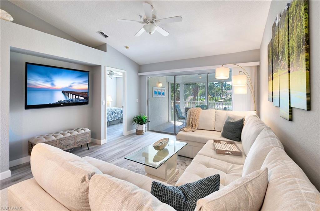 9022 Michael Circle, Unit 2210 Naples, FL 34113 - Photo 5 of 36 a living room with furniture and a large window