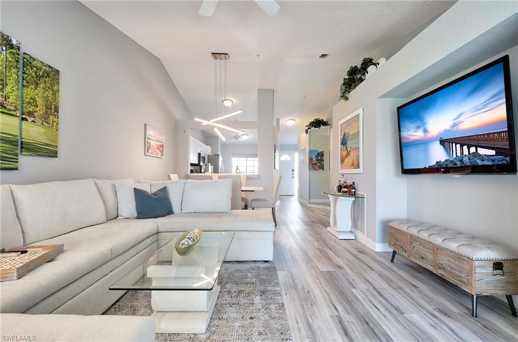 9022 Michael Circle, Unit 2210 Naples, FL 34113 - Photo 6 of 36 a living room with furniture and a flat screen tv