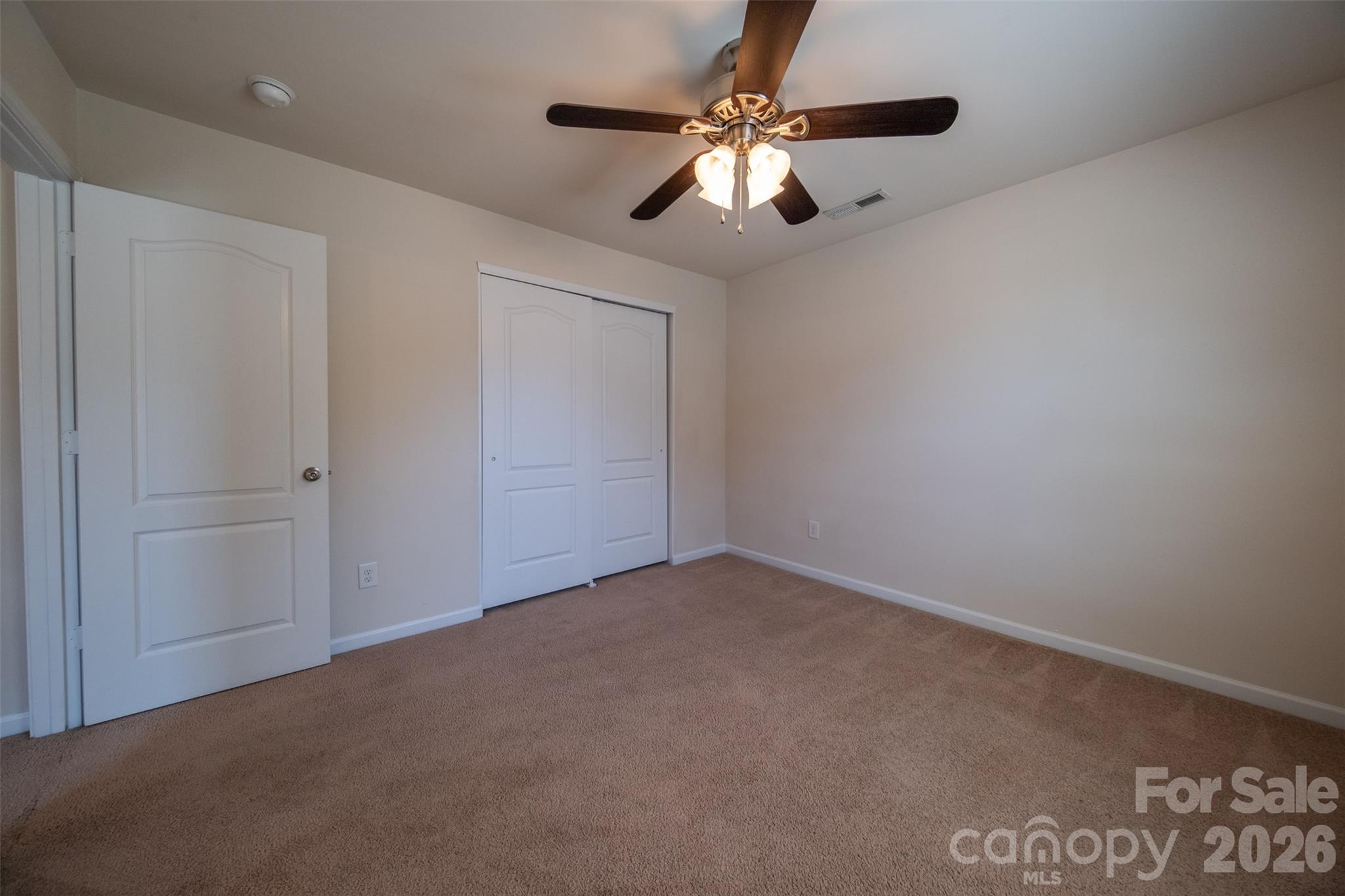 3006 Houndscroft Road Indian Trail, NC 28079 - Photo 24 of 39 an empty room with a chandelier fan and windows