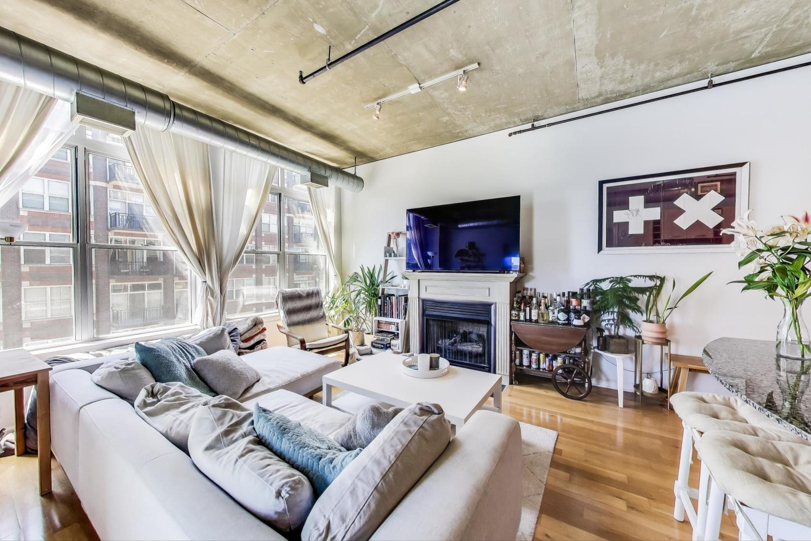 111 South Morgan Street, Unit 510 Chicago, IL 60607 - Photo 12 of 38 a living room with furniture large window and a fireplace