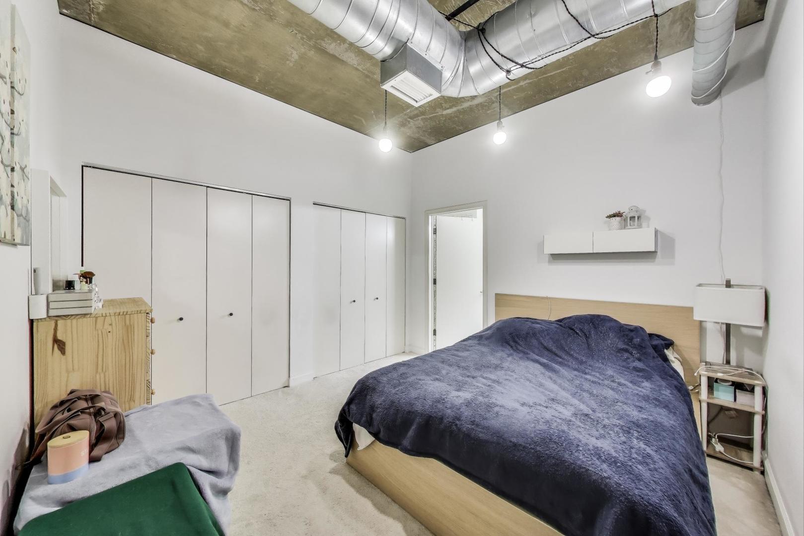 111 South Morgan Street, Unit 510 Chicago, IL 60607 - Photo 27 of 38 a bedroom with a bed and a table in it