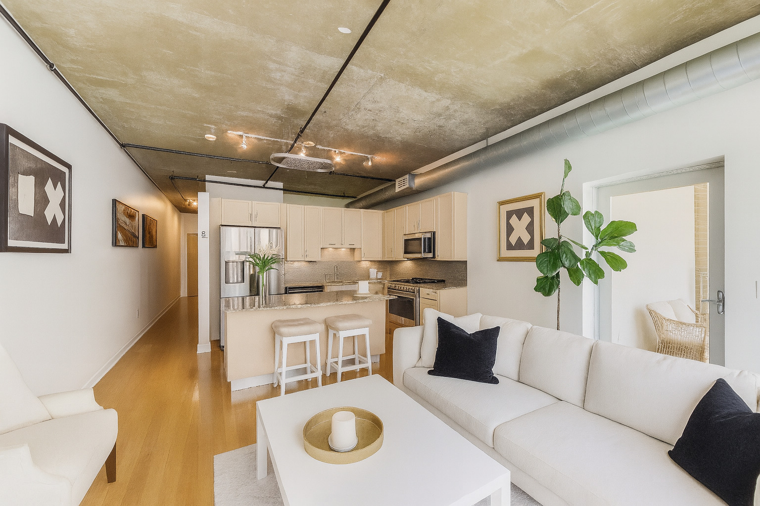111 South Morgan Street, Unit 510 Chicago, IL 60607 - Photo 3 of 38 a living room with stainless steel appliances furniture a rug and a kitchen view