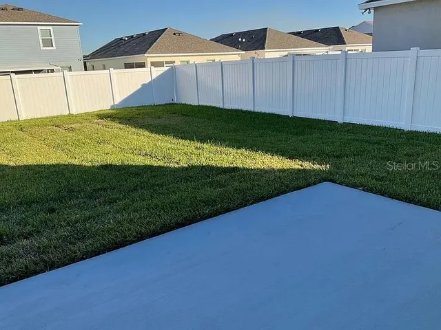 a view of a backyard with potted plants
