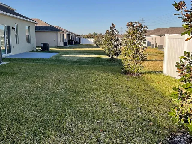 a house view with swimming pool in front of it