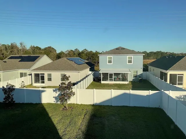 a front view of a house with a garden and yard