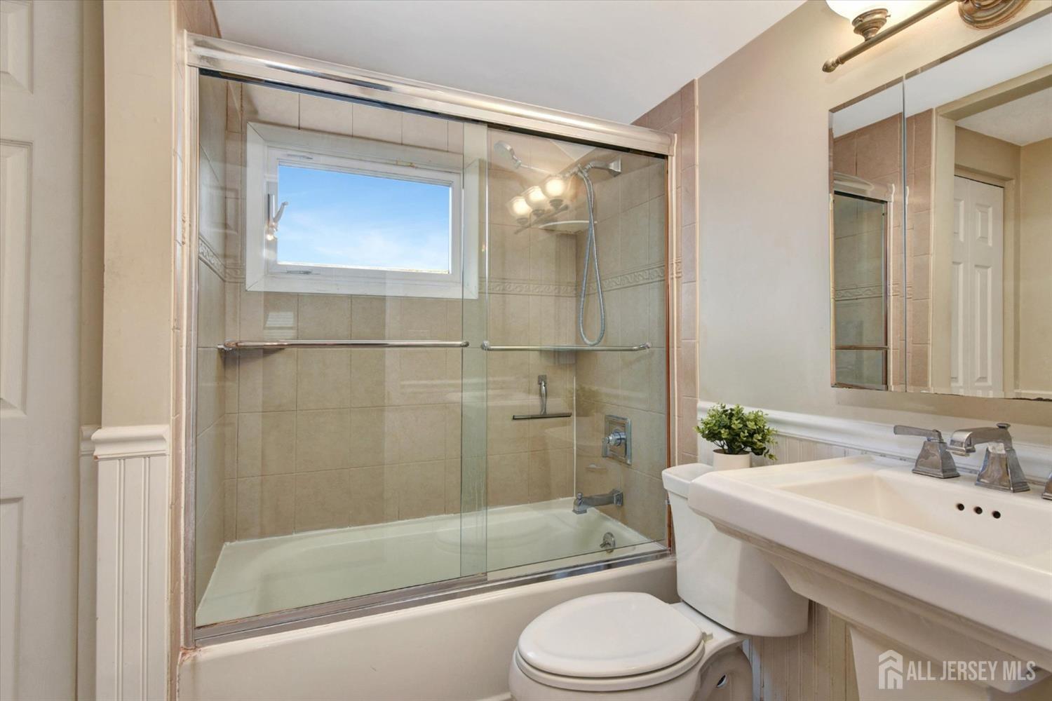 12 Albert Drive Old Bridge, NJ 08857 - Photo 11 of 20 a bathroom with a bathtub shower sink mirror vanity and toilet