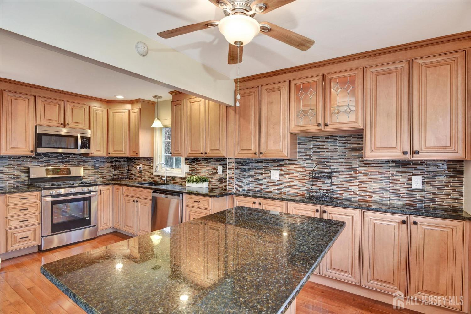 12 Albert Drive Old Bridge, NJ 08857 - Photo 3 of 20 a kitchen with stainless steel appliances granite countertop a sink stove and cabinets