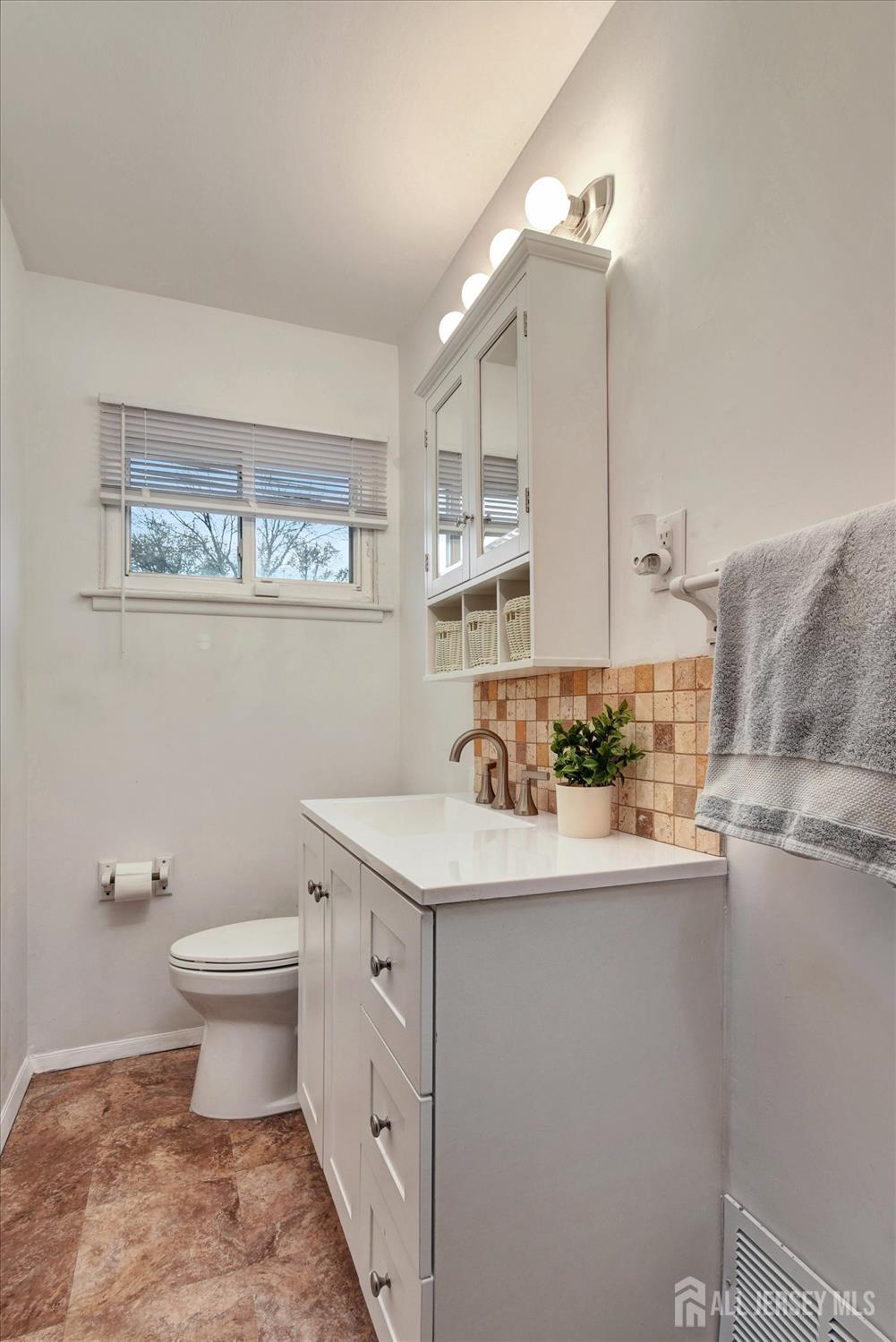 12 Albert Drive Old Bridge, NJ 08857 - Photo 9 of 20 a bathroom with a sink a toilet and mirror