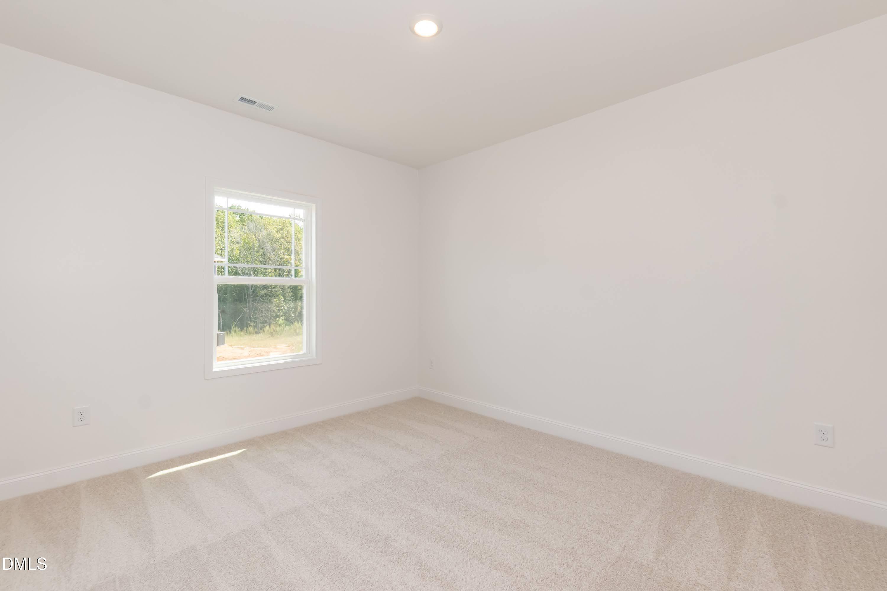 254 Galway Road Lillington, NC 27546 - Photo 28 of 35 an empty room with a window