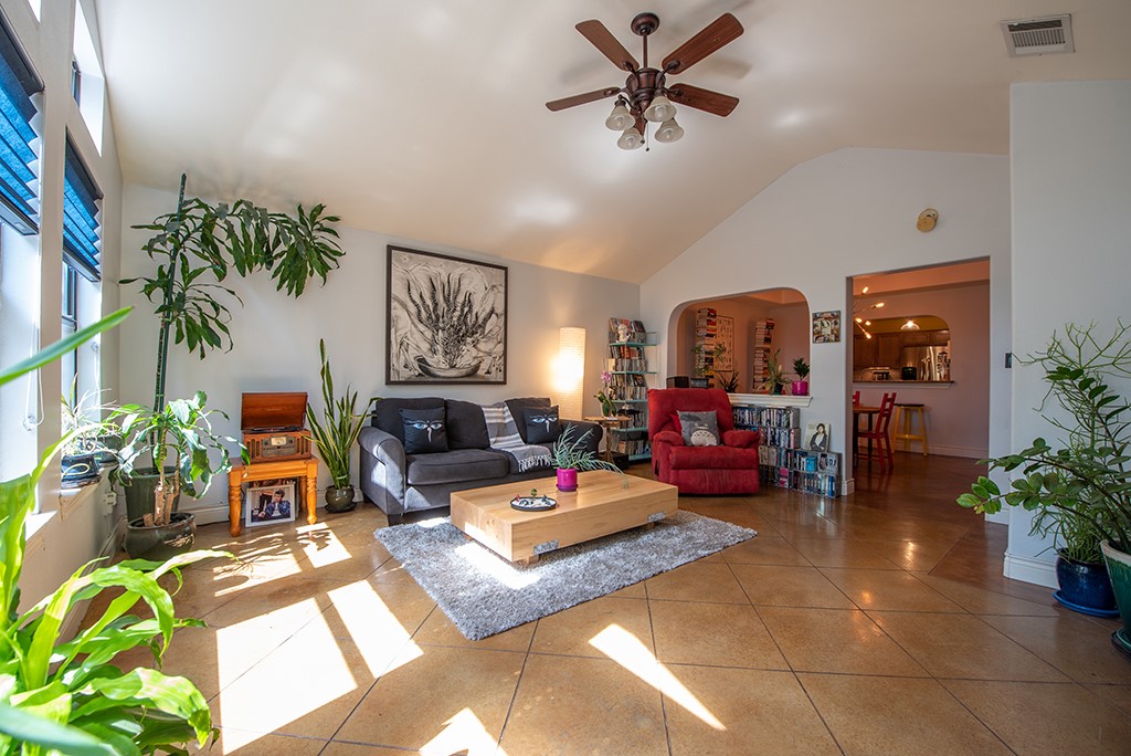 3609 Clawson Road, Unit A Austin, TX 78704 - Photo 2 of 17 A naturally illuminated living area features high vaulted ceilings and durable tile flooring, creating an inviting space.