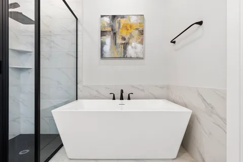 a white bath tub sitting in a bathroom