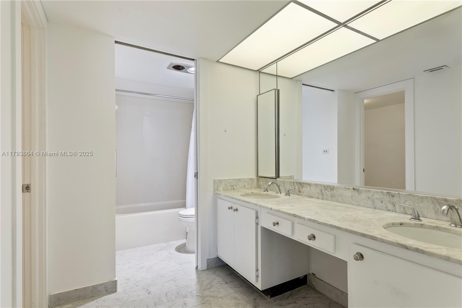 1121 Crandon Boulevard, Unit E1204 Key Biscayne, FL 33149 - Photo 13 of 21 a bathroom with a granite countertop sink mirror and a bathtub