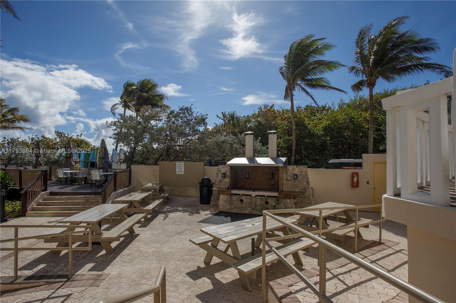 1121 Crandon Boulevard, Unit E1204 Key Biscayne, FL 33149 - Photo 19 of 21 a view of a chairs and tables in the patio