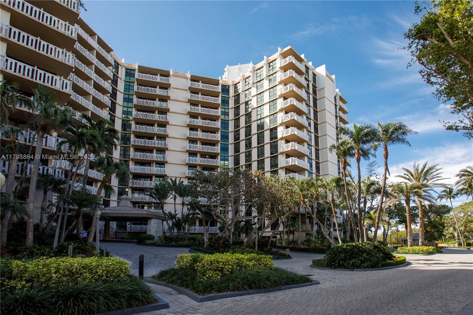 1121 Crandon Boulevard, Unit E1204 Key Biscayne, FL 33149 - Photo 21 of 21 a front view of multi story residential apartment building with yard and parking space