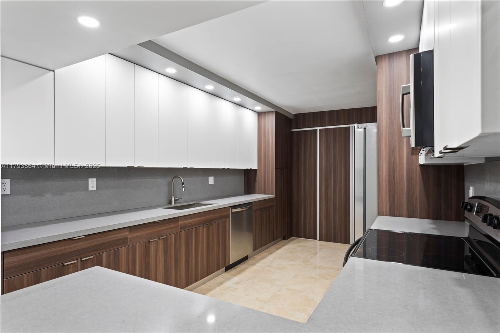 1121 Crandon Boulevard, Unit E1204 Key Biscayne, FL 33149 - Photo 5 of 21 a kitchen with stainless steel appliances a sink stove and refrigerator