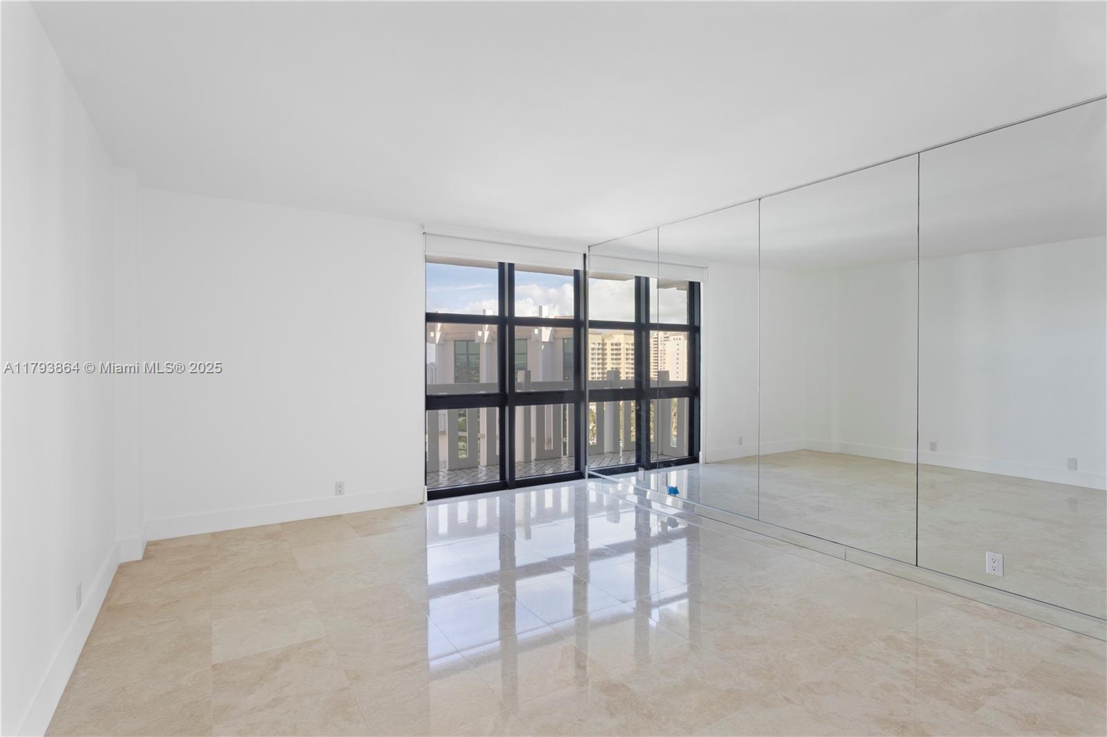 1121 Crandon Boulevard, Unit E1204 Key Biscayne, FL 33149 - Photo 9 of 21 a view of wooden floor and windows in a room